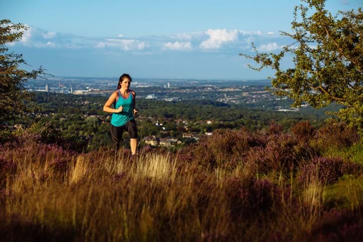 Outdoor countryside running with city view