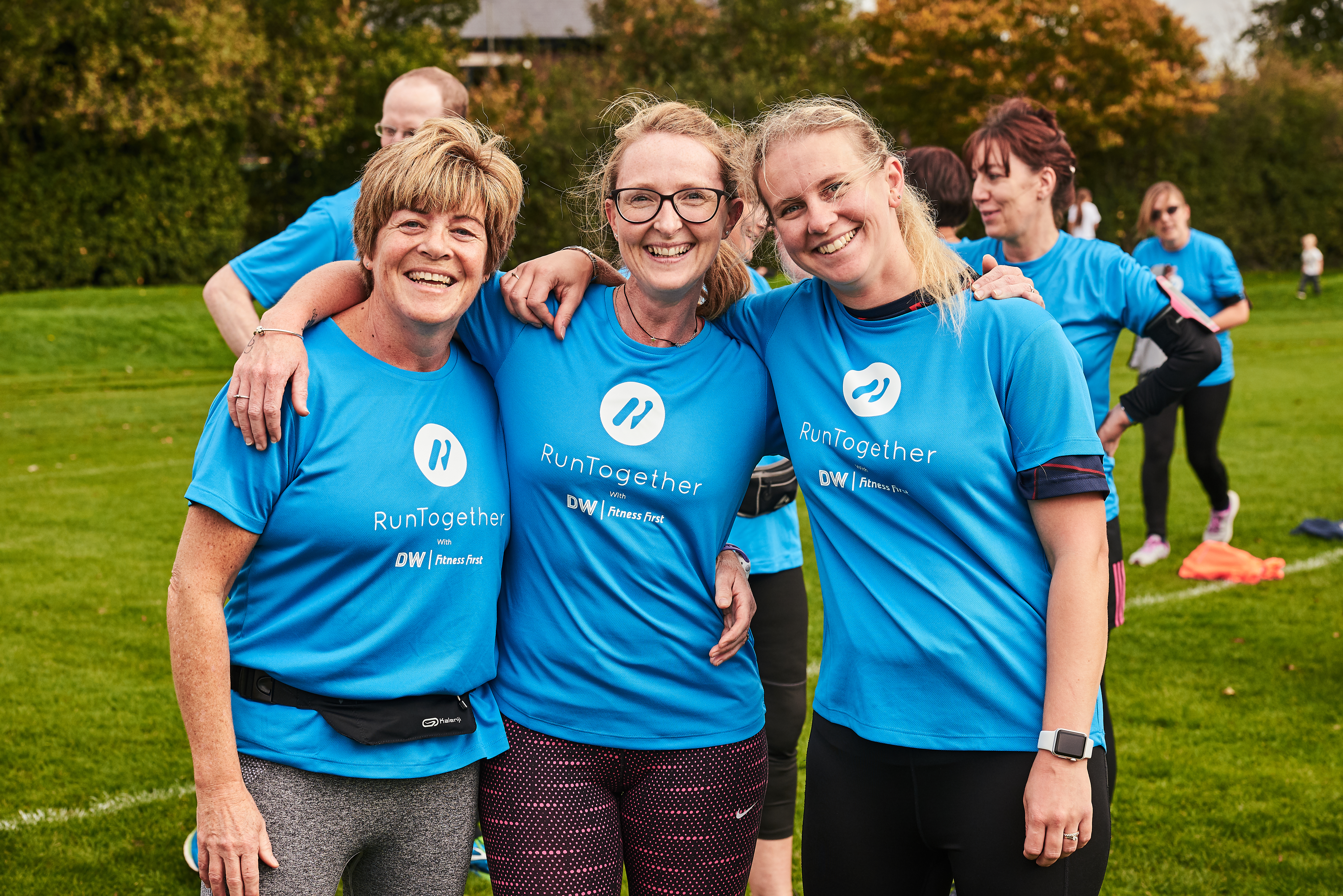 group of 3 smiling runners