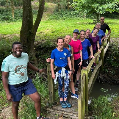 running group on bridge in woods